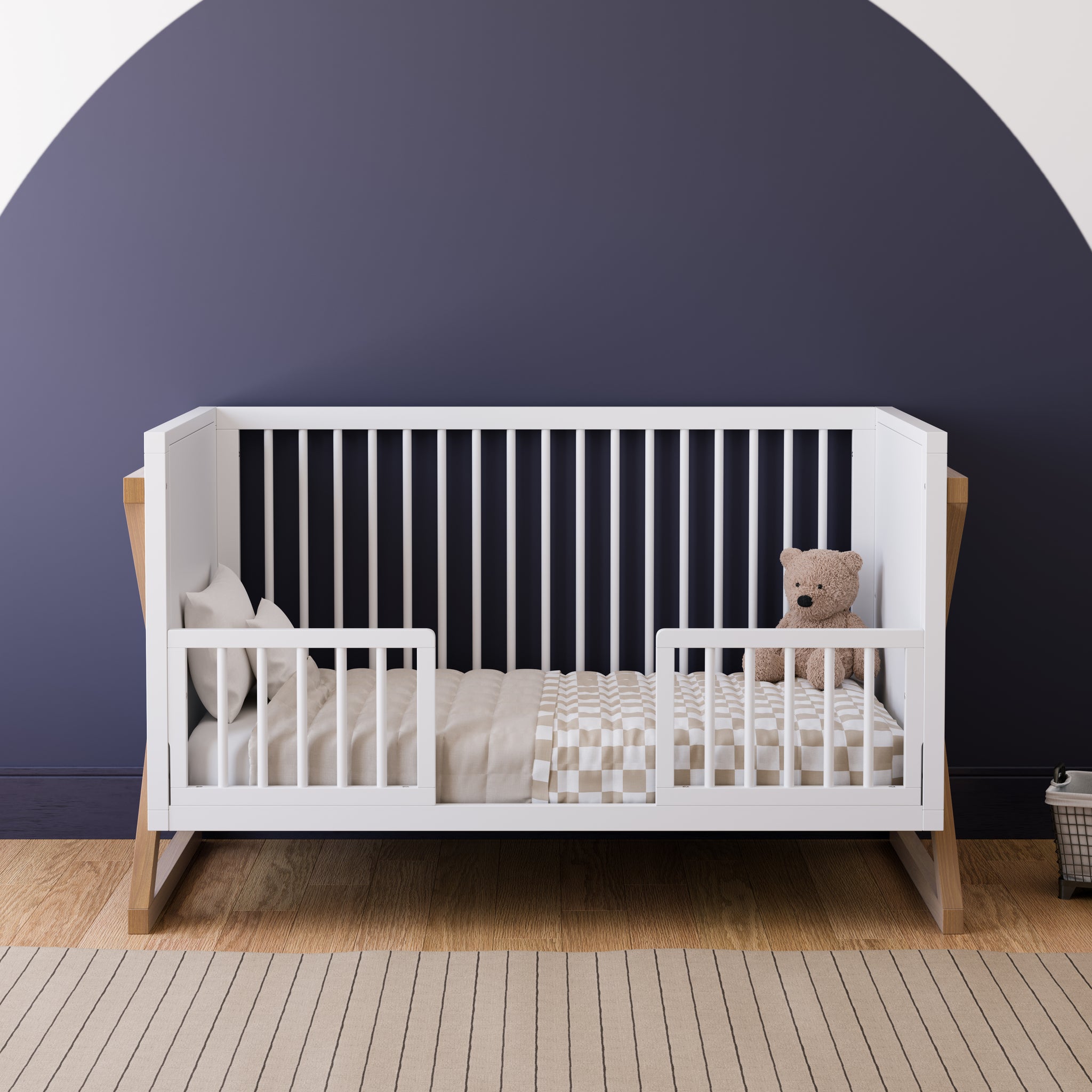 white and vintage driftwood crib toddler bed conversion with two guardrail in nursery