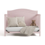 paris blush crib daybed conversion with pillows, blanket, and teddy bear