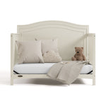 paris frosted oat crib daybed conversion with pillows, blanket, and teddy bear