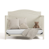 paris frosted oat crib daybed conversion with pillows, blanket, and teddy bear
