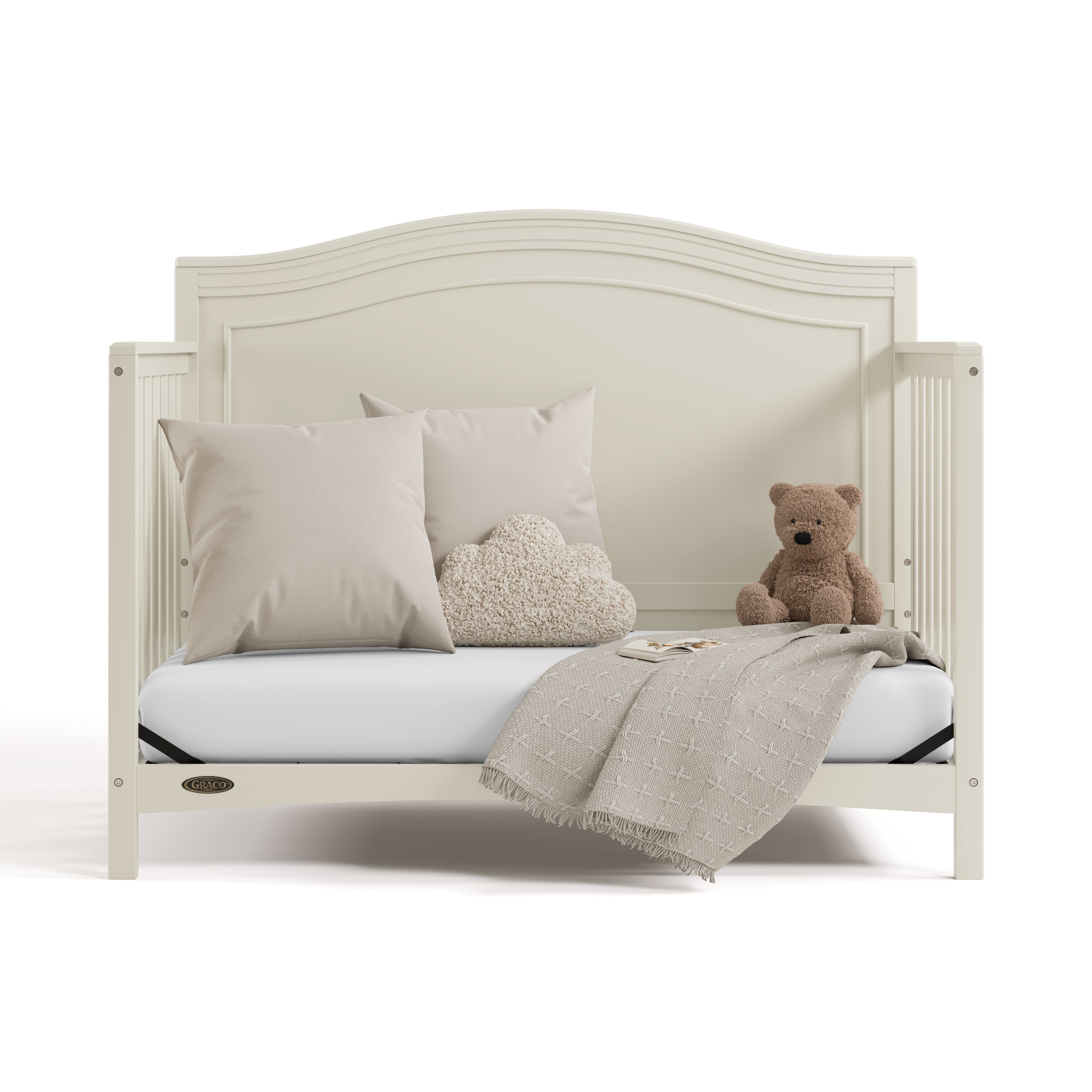 paris frosted oat crib daybed conversion with pillows, blanket, and teddy bear