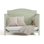paris sage crib daybed conversion with pillows, blanket, and teddy bear