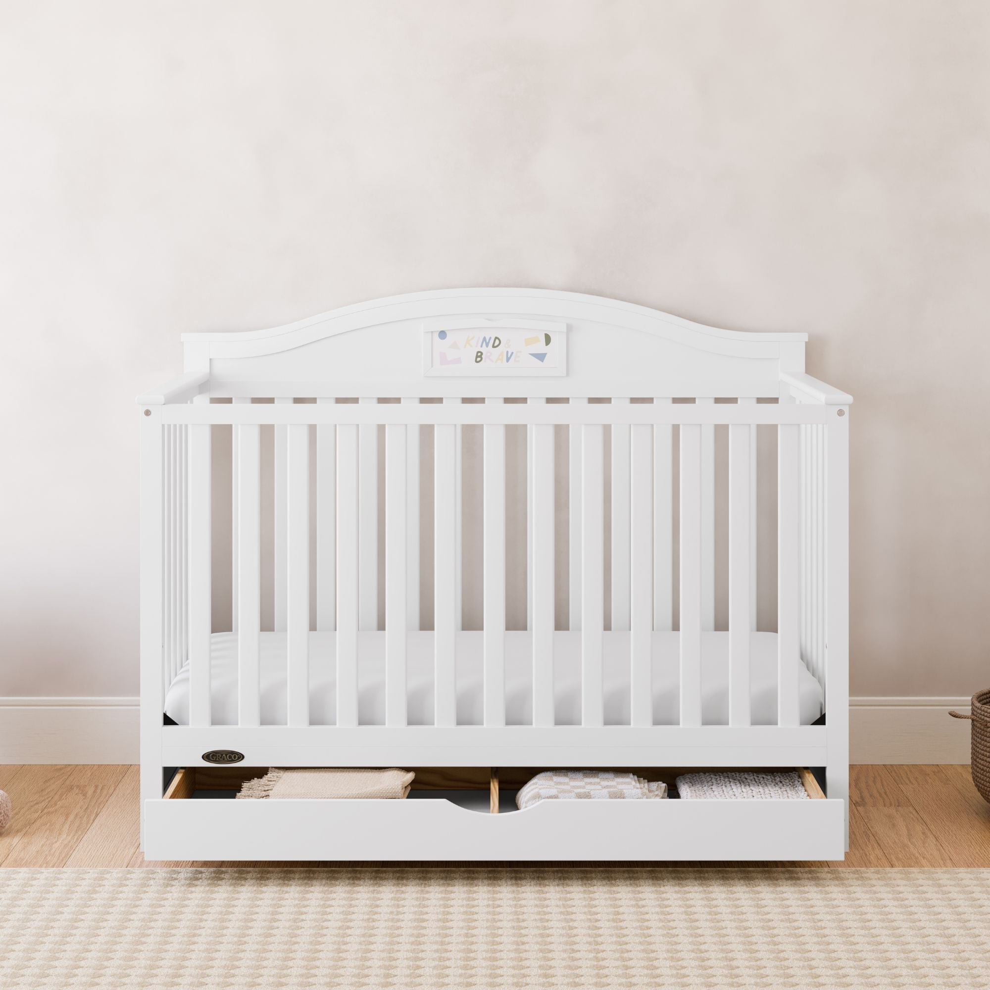 graco story white crib with drawer in nursery