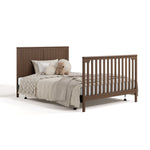 Hadley hazelnut crib and changer converted to full-size bed with footboard