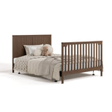 Hadley hazelnut crib and changer converted to full-size bed with footboard