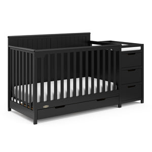 black crib and changer angled with drawer
