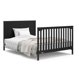black crib and changer with drawer in full-size bed with headboard and footboard conversion