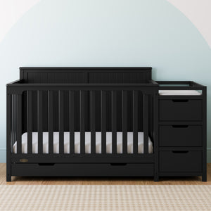 black crib and changer with drawer in nursery