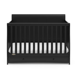 Front view of black crib with drawer