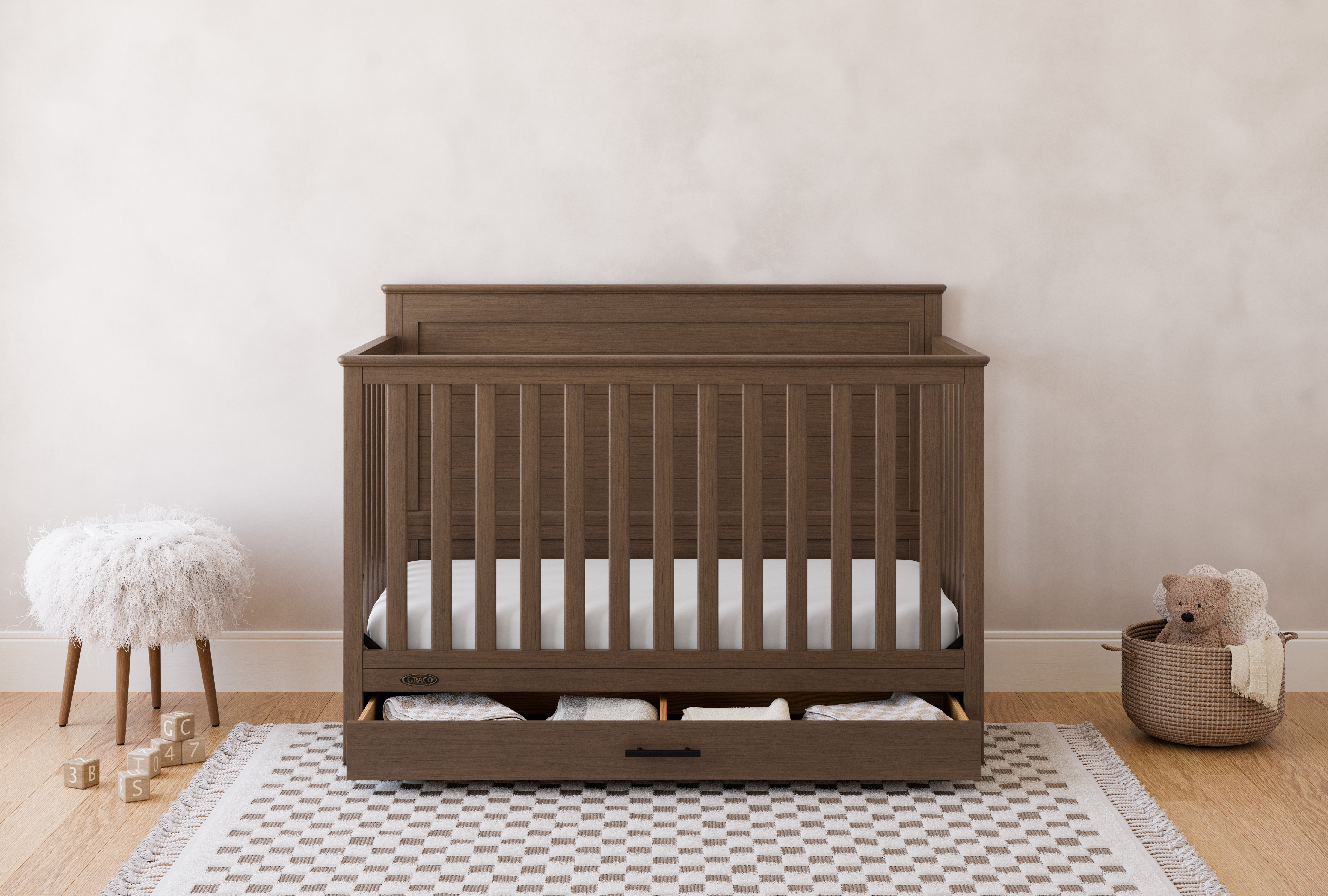graco tristan hazelnut crib with drawer in nursery