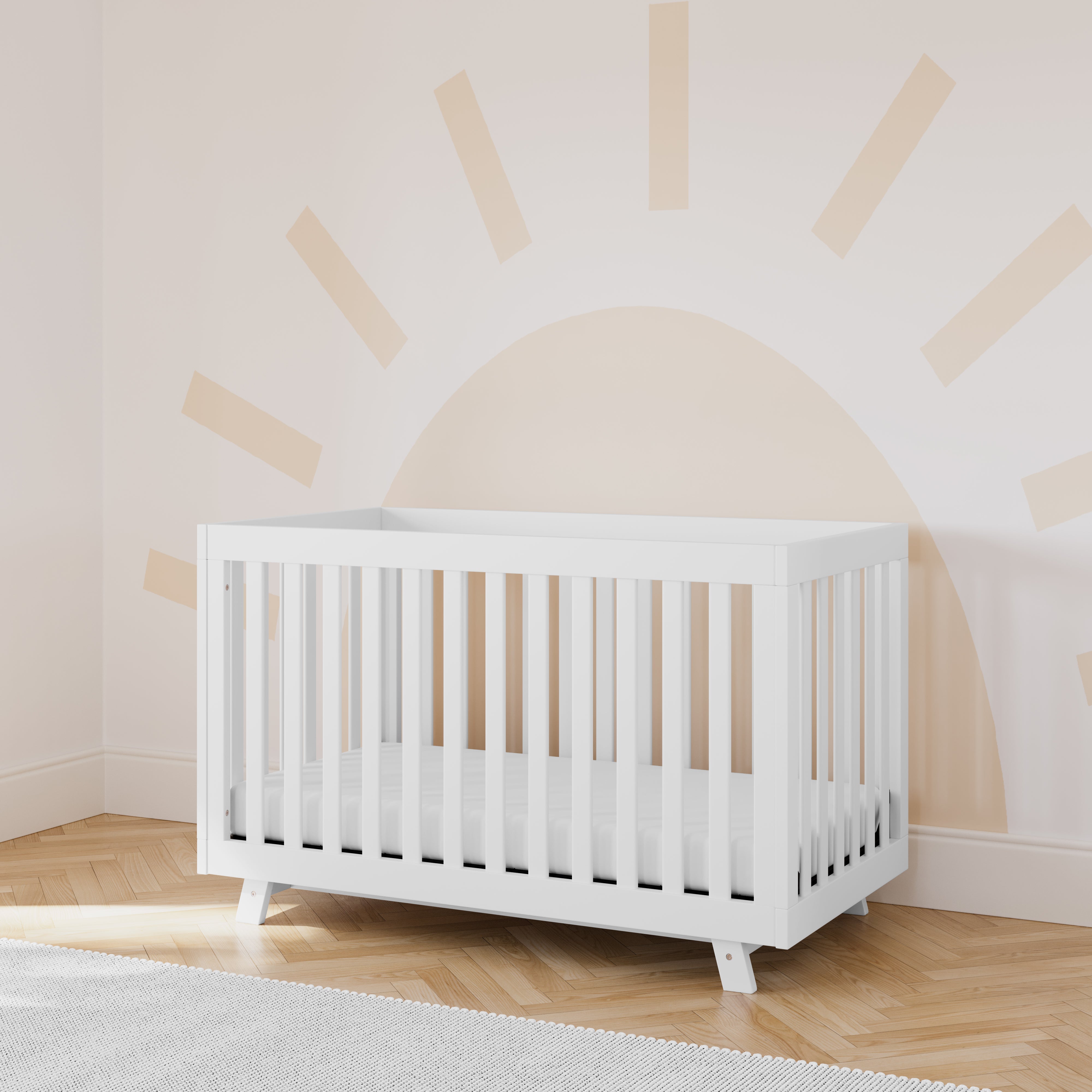 storkcraft beckett white crib in nursery with sun wallpaper in back