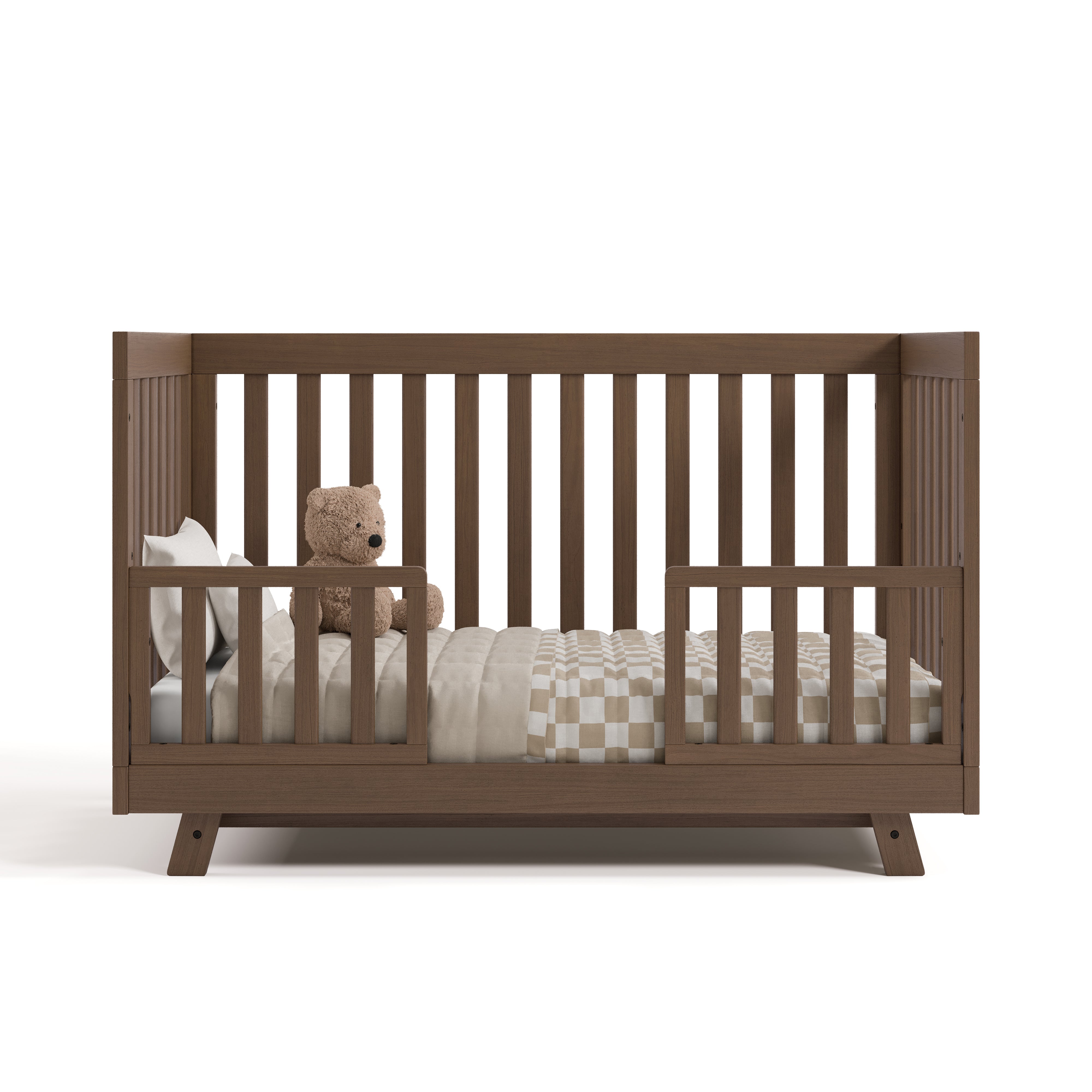Beckett hazelnut crib converted to toddler bed with two guardrails