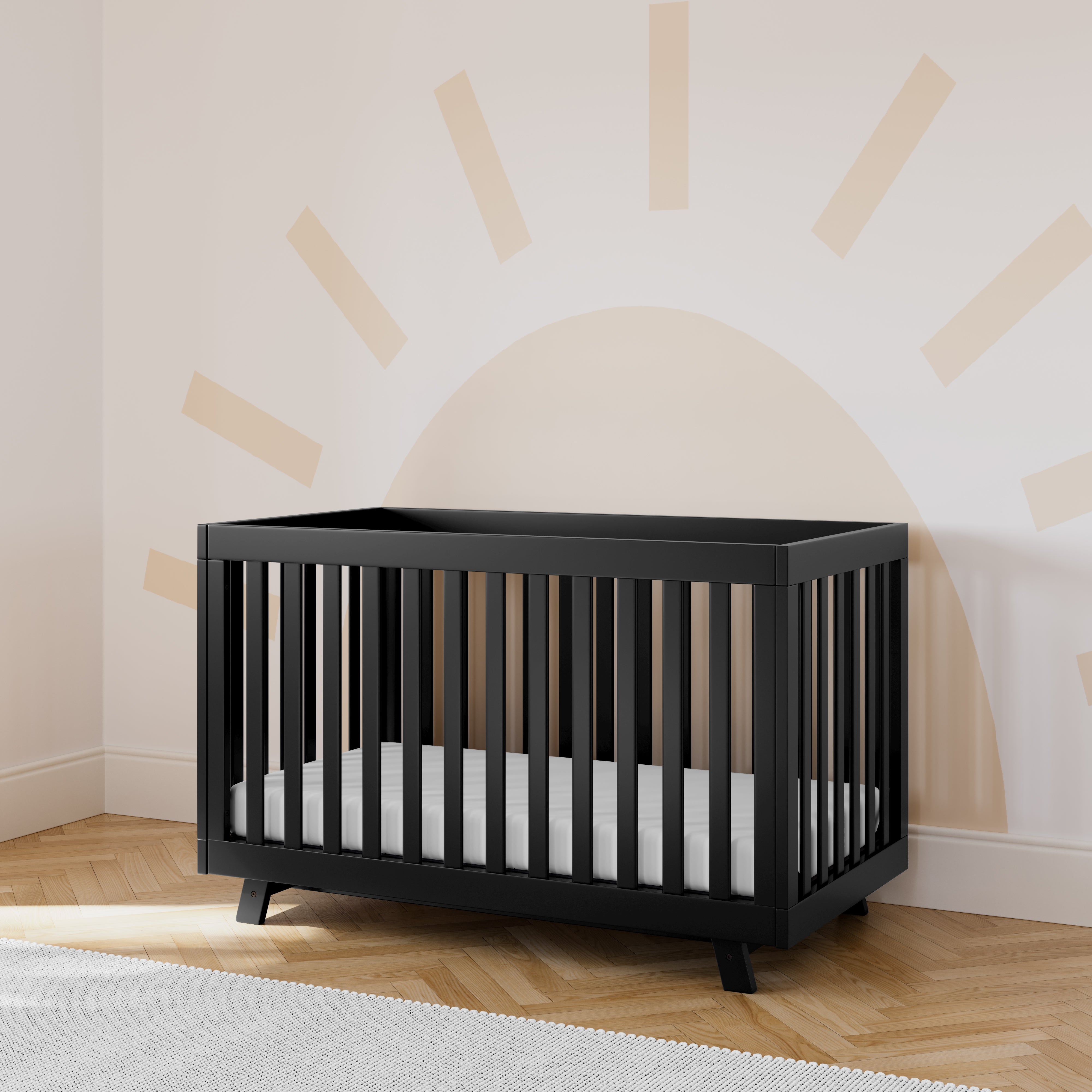 storkcraft beckett black crib in nursery with sun wallpaper in back