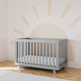 storkcraft beckett pebble gray crib in nursery with sun wallpaper in back
