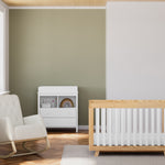 Beckett natural with white crib in nursery next to rocker and changing dresser