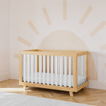 storkcraft beckett natural with white crib in nursery with sun wallpaper in back