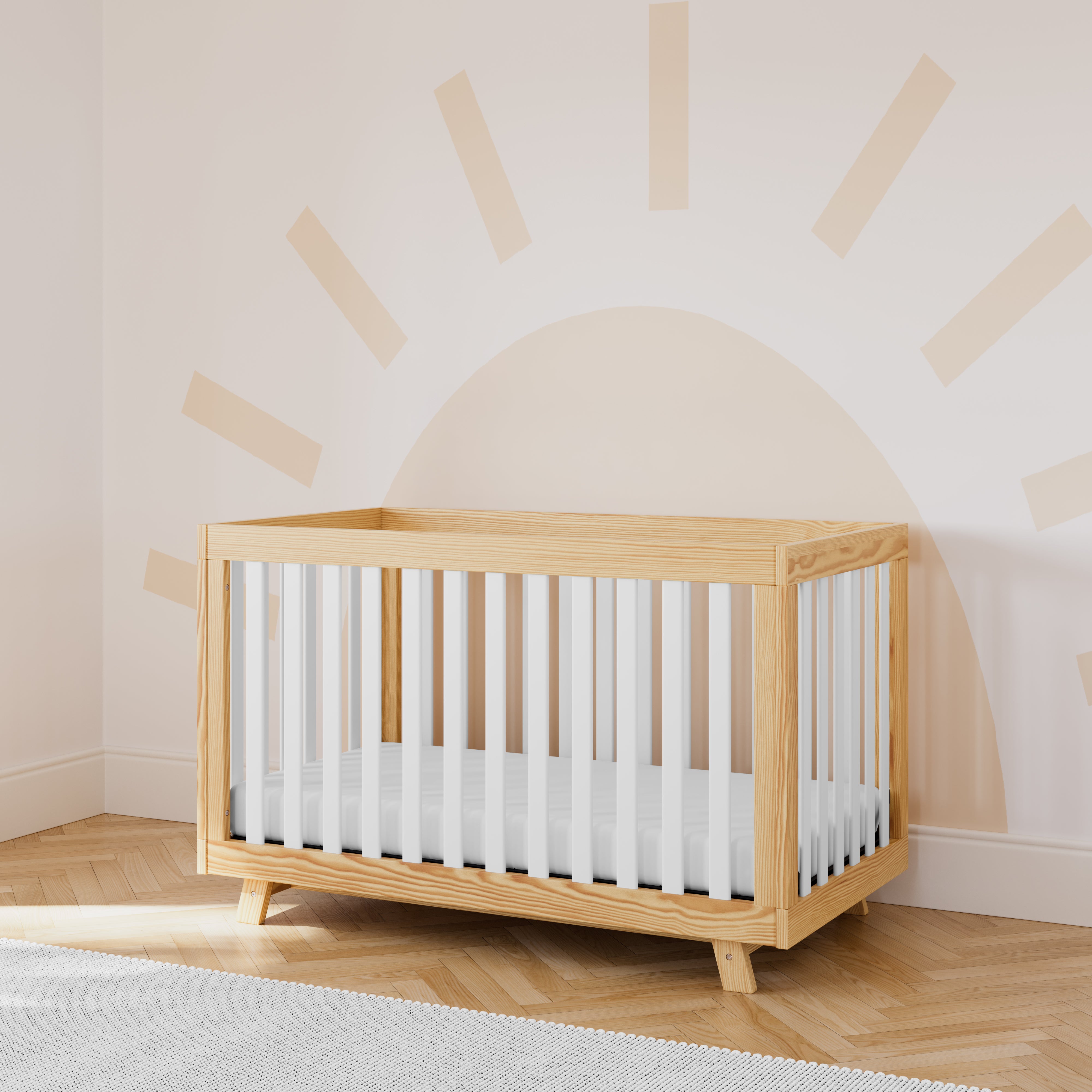 storkcraft beckett natural with white crib in nursery with sun wallpaper in back