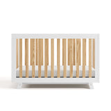 Front view of Beckett crib in white with natural
