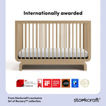 storkcraft driftwood crib with multiple award logos on bottom