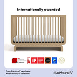 storkcraft driftwood crib with multiple award logos on bottom