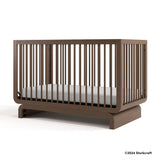 Santorini hazelnut crib with 2024 Storkcraft copyright on bottom right