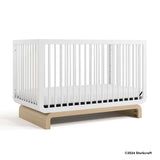 Santorini white with driftwood crib with 2024 Storkcraft copyright on bottom right