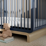 Santorini midnight blue with driftwood crib in a nursery