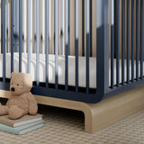 Santorini midnight blue with driftwood crib in a nursery