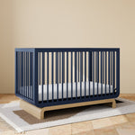 Santorini midnight blue with driftwood crib in a nursery