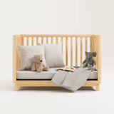 storkcraft santos natural crib studio daybed conversion with pillows and teddy bears
