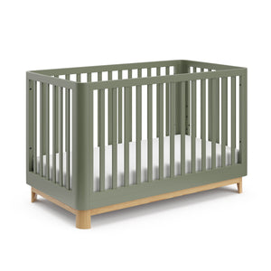 Angled view of an olive crib with a natural wood color base