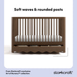 Casablanca hazelnut crib front view showing soft waves and rounded posts callout image