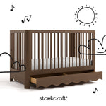 Casablanca hazelnut crib angle view with drawer open and black cartoon drawings overlaid on image