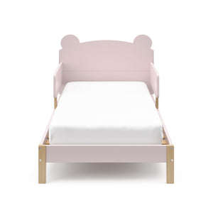 front view of a blush-colored toddler bed