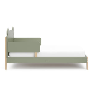 side view of a olive-colored toddler bed