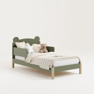 Angled view of a olive-colored toddler bed