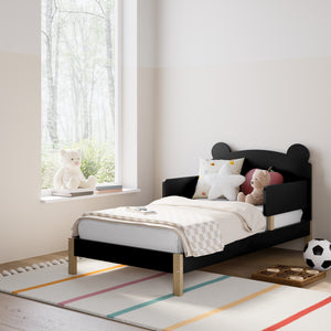 Black-colored toddler bed in nursery
