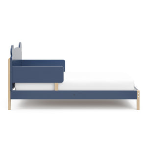 side view of a blue-colored toddler bed