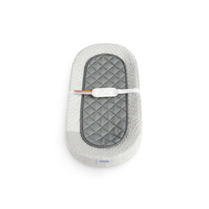 front view of an oval changing pad with a textured cover and liner