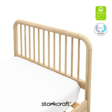 Top view of the corner of a twin bed showing the headboard and certification seals