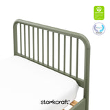 Top view of the corner of a twin bed showing the headboard and certification seals