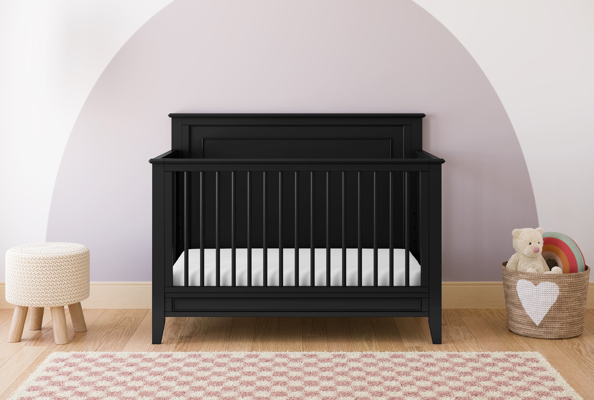 black crib with dowels and solid headboard in nursery