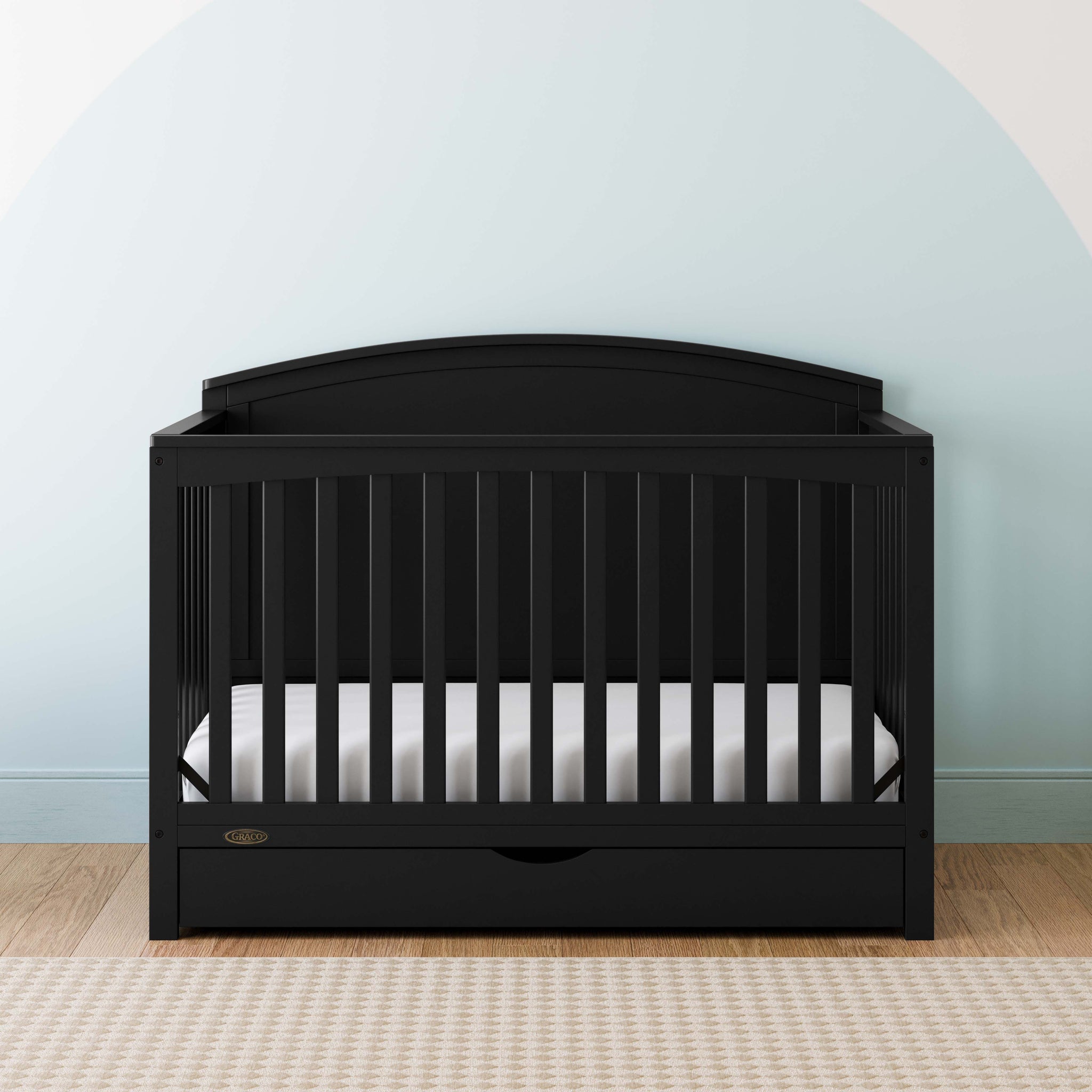Convertible black crib in a nursery