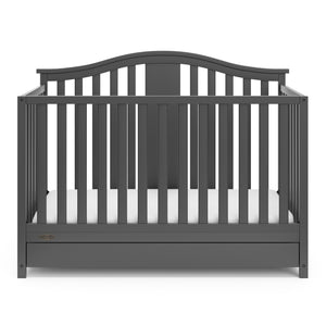 Front view of gray crib with drawer
