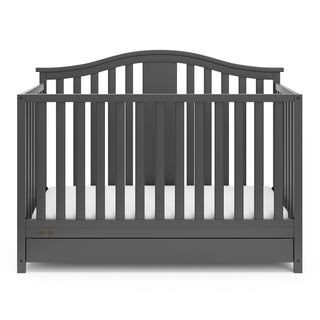 Front view of gray crib with drawer