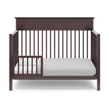espresso crib in toddler bed conversion with one safety guardrail