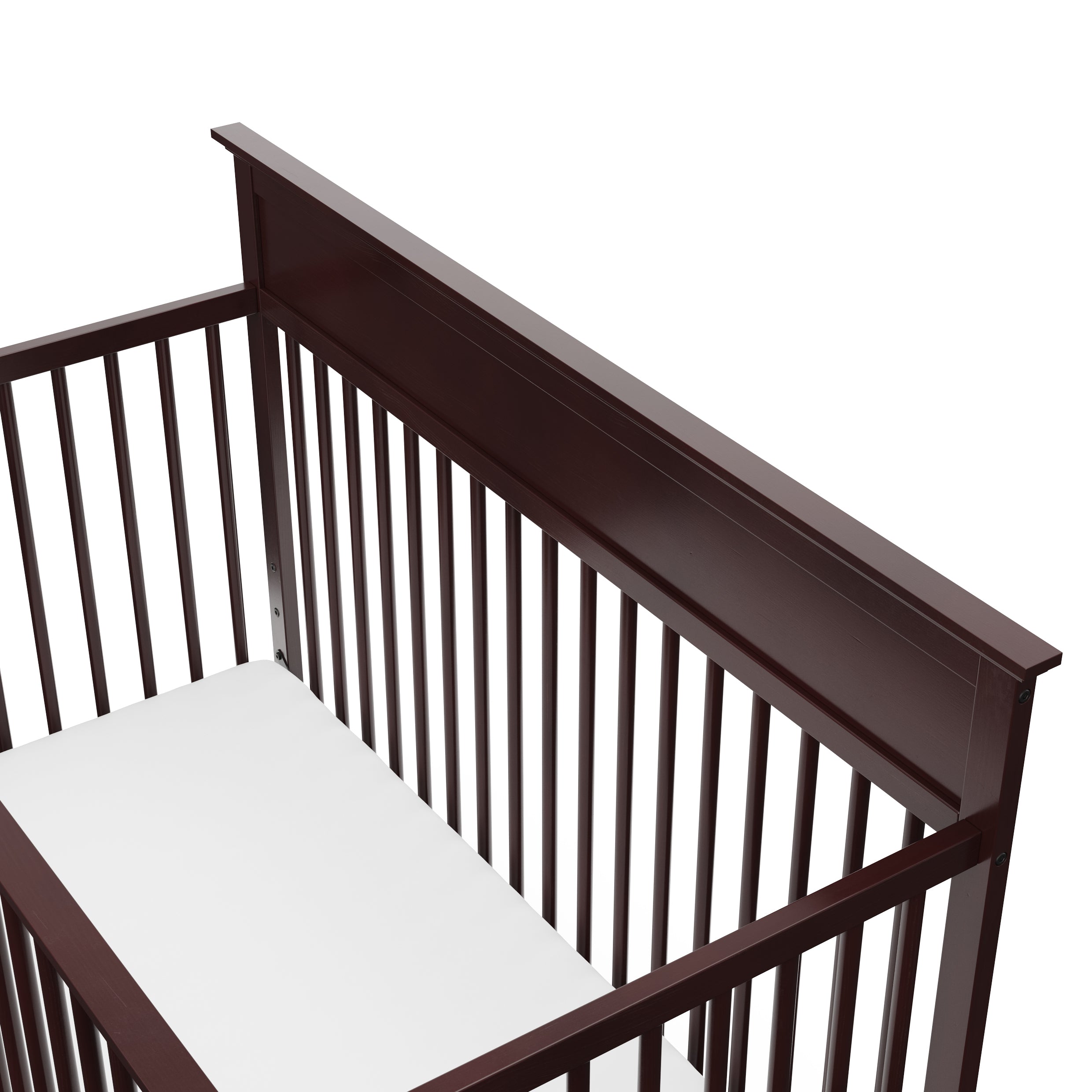 Close-up view of espresso crib's headboard