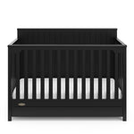 front view of black crib with drawer