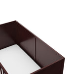 Close-up view of espresso crib's headboard