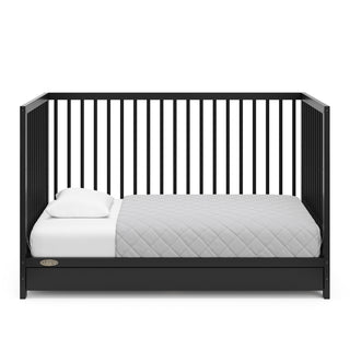 Black crib with drawer in toddler bed conversion